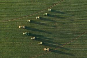 drone photo of tractors from above in v shape