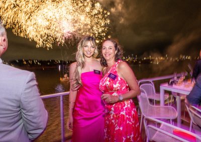 social image of two woman with firworks behind